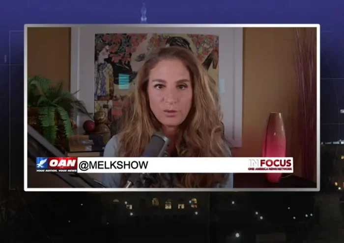Video still from In Focus on One America News Network during an interview with the guest, Mel K.