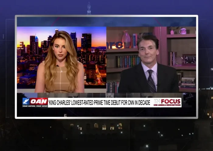 Video still from In Focus on One America News Network showing a split screen of the host on the left side, and on the right side is the guest, Eric Scheiner.