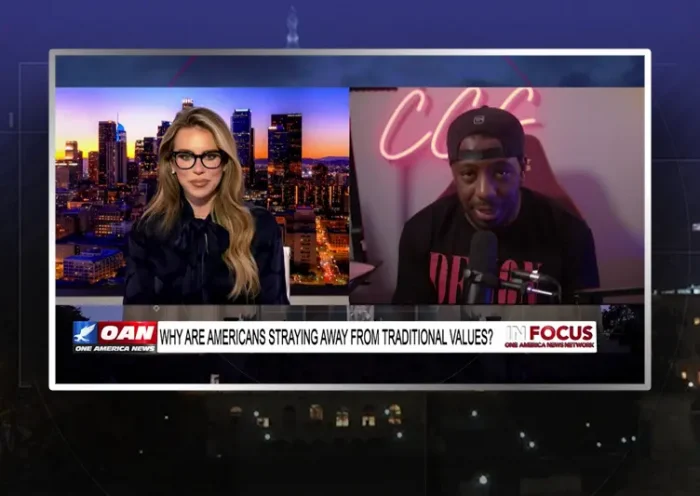 Video still from In Focus on One America News Network showing a split screen of the host on the left side, and on the right side is the guest, Bryson Gray.
