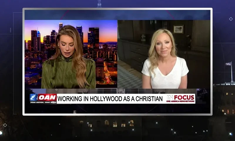 Video still from In Focus on One America News Network showing a split screen of the host on the left side, and on the right side is the guest, Leigh Allyn Baker.
