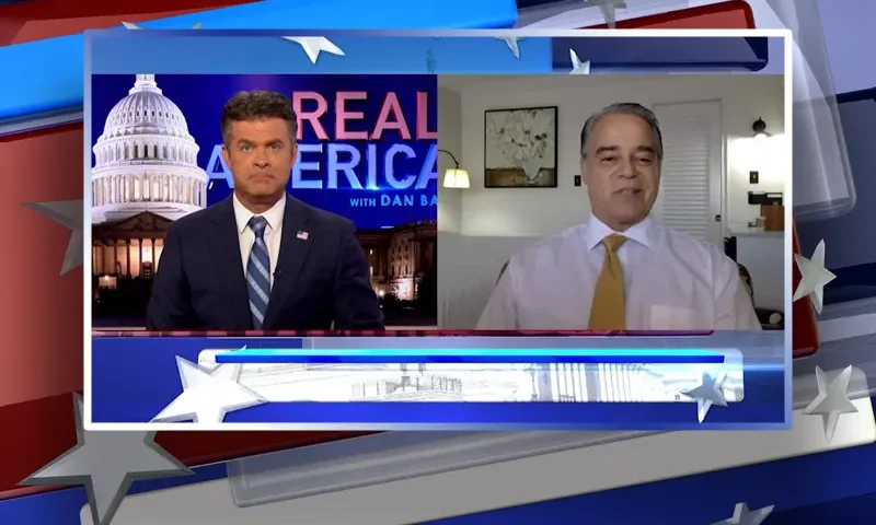 Video still from Real America on One America News Network showing a split screen of the host on the left side, and on the right side is the guest, Frank Panico.