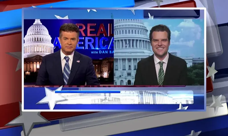 Video still from Real America on One America News Network showing a split screen of the host on the left side, and on the right side is the guest, Rep. Matt Gaetz.