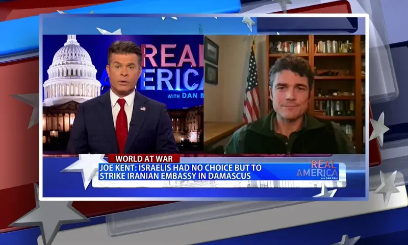 Video still from Real America on One America News Network showing a split screen of the host on the left side, and on the right side is the guest, Joe Kent.
