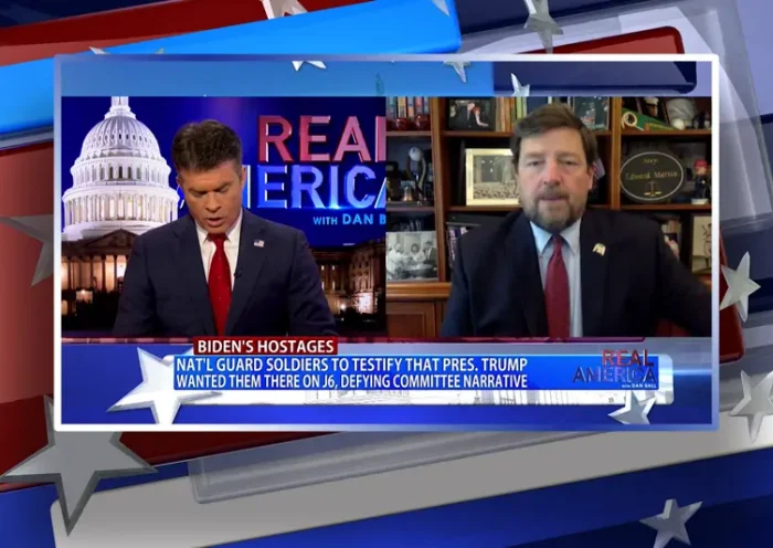 Video still from Real America on One America News Network showing a split screen of the host on the left side, and on the right side is the guest, Ed Martin.
