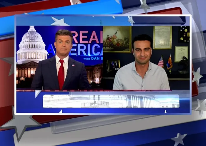 Video still from Real America on One America News Network showing a split screen of the host on the left side, and on the right side is the guest, Abe Hamadeh.