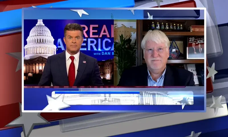 Video still from Real America on One America News Network showing a split screen of the host on the left side, and on the right side is the guest, Joe Hoft.