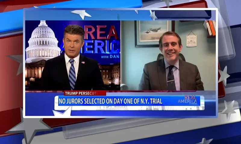 Video still from Real America on One America News Network showing a split screen of the host on the left side, and on the right side is the guest, Jesse Binnall.
