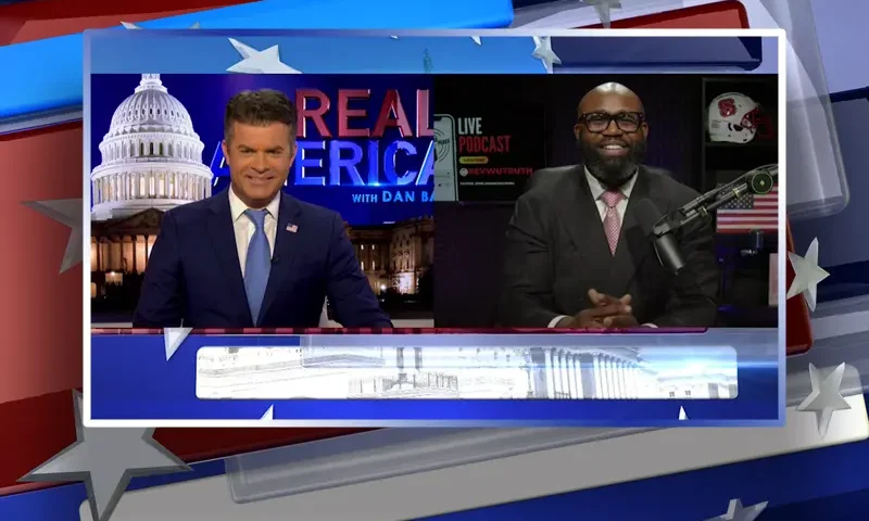 Video still from Real America on One America News Network showing a split screen of the host on the left side, and on the right side is the guest, John Amanchukwu.