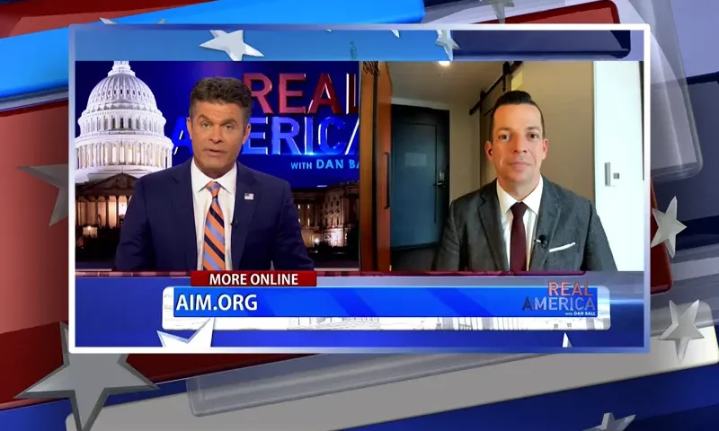 Video still from Real America on One America News Network showing a split screen of the host on the left side, and on the right side is the guest, Adam Guillette.