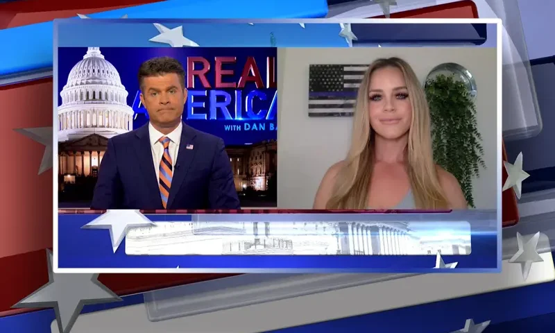 Video still from Real America on One America News Network showing a split screen of the host on the left side, and on the right side is the guest, Meagan McCarthy.