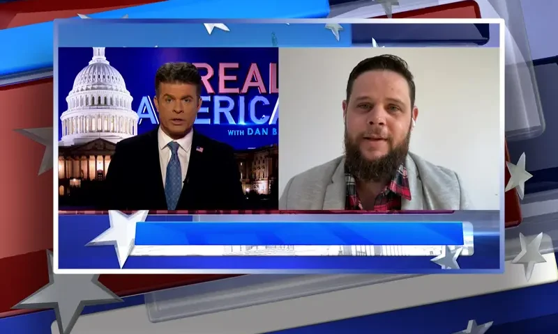 Video still from Real America on One America News Network showing a split screen of the host on the left side, and on the right side is the guest, Ricardo Martins.