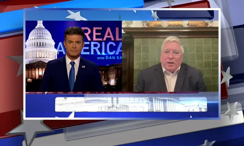 Video still from Real America on One America News Network showing a split screen of the host on the left side, and on the right side is the guest, Patrick Morrisey.