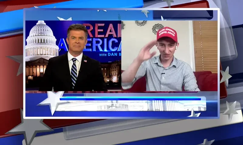 Video still from Real America on One America News Network showing a split screen of the host on the left side, and on the right side is the guest, Maison Deschamps.