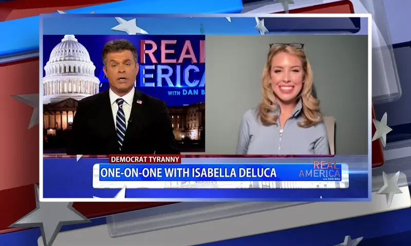 Video still from Real America on One America News Network showing a split screen of the host on the left side, and on the right side is the guest, Isabella DeLuca.