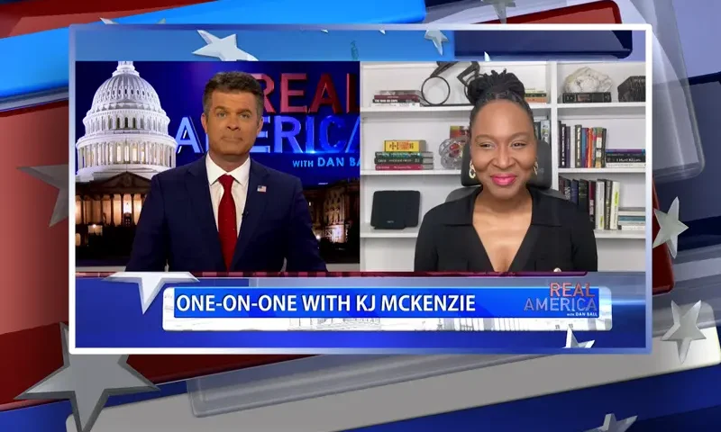 Video still from Real America on One America News Network showing a split screen of the host on the left side, and on the right side is the guest, KJ McKenzie.