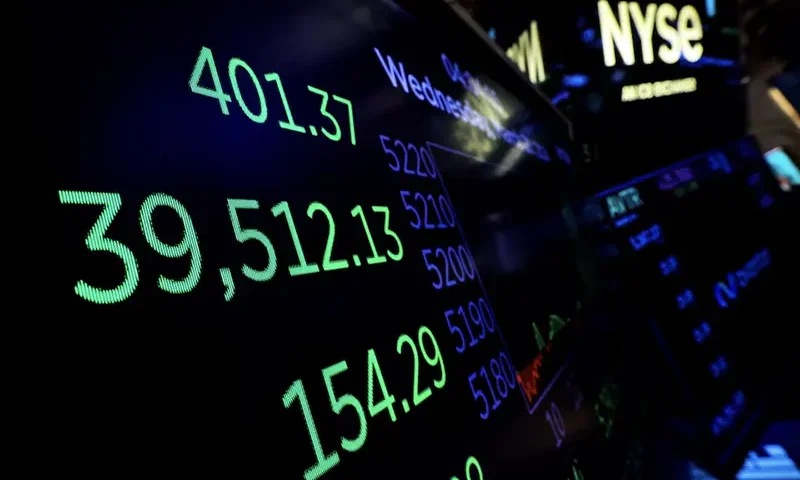 A screen displays the Dow Jones Industrial Average after the close of trading for the day on the floor at the New York Stock Exchange (NYSE) in New York City, U.S., March 20, 2024. REUTERS/Brendan McDermid/file photo