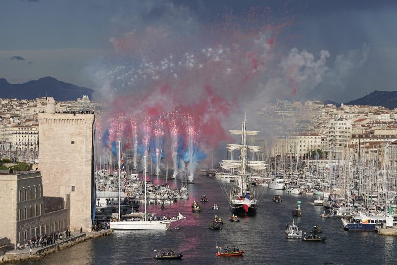 Fireworks go off as the Belem, the three-masted sailing ship bringing the Olympic flame from Greece, enters the Old Port in Marseille, southern France, Wednesday, May 8, 2024. After leaving Marseille, a vast relay route is undertaken before the torch odyssey ends on July 27 in Paris. The Paris 2024 Olympic Games will run from July 26 to Aug.11, 2024. (AP Photo/Laurent Cipriani)
