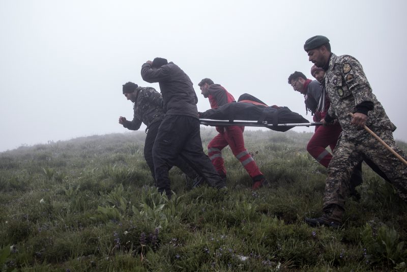 In this photo provided by Moj News Agency, rescue teams members carry the body of a victim after a helicopter carrying Iranian President Ebrahim Raisi crashed in Varzaghan, northwestern Iran, Monday, May 20, 2024. Iranian President Ebrahim Raisi, the country’s foreign minister and others have been found dead at the site of a helicopter crash after an hours-long search through a foggy, mountainous region of the country’s northwest, state media reported. (Azin Haghighi, Moj News Agency via AP)