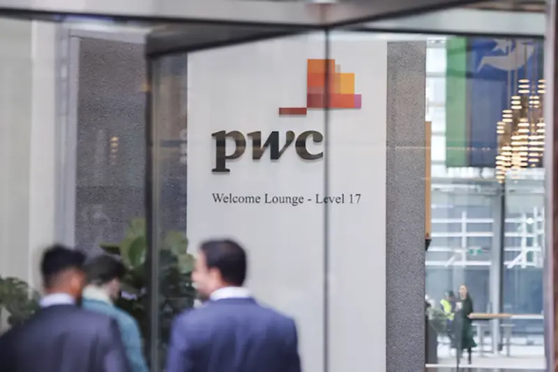 PwC sign is seen in the lobby of their offices in Barangaroo, Australia June 22, 2023. REUTERS/Lewis Jackson/ file photo