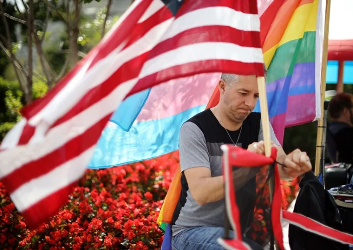 WASHINGTON, DC - OCTOBER 07: Eddie Reynoso of San Diego, California, attaches an American flag his chair while waiting in line outside the U.S. Supreme Court building for the chance to attend Tuesday's arguments during the court's new term October 07, 2019 in Washington, DC. In place outside the court since Saturday night, Reynoso is first in line to hear Tuesday's arguments in Bostock v. Clayton Co., GA, where the justices will consider whether employers may fire employees for being gay or transgender. With Chief Justice John Roberts in the lead, the court is scheduled to hear cases involving gun control, abortion, L.G.B.T. rights and immigration during this term. (Photo by Chip Somodevilla/Getty Images)