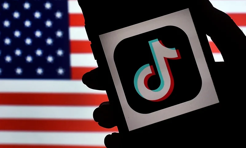 US-IT-CHINA-POLITICS-TIKTOK In this photo illustration, the social media application logo, TikTok is displayed on the screen of an iPhone on an American flag background on August 3, 2020 in Arlington, Virginia. - The US Senate voted on August 6, 2020, to bar TikTok from being downloaded onto US government employees' telephones, intensifying US scrutiny of the popular Chinese-owned video app. The bill passed by the Republican controlled Senate now goes to the House of Representatives, led by Democrats. (Photo by Olivier DOULIERY / AFP) (Photo by OLIVIER DOULIERY/AFP via Getty Images)