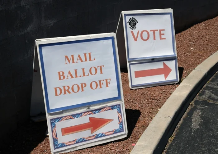 NORTH LAS VEGAS, NEVADA - JUNE 09: Signs direct people to the entrance of the Clark County Election Department, which is serving as both a primary election ballot drop-off point and an in-person voting center amid the coronavirus pandemic on June 9, 2020 in North Las Vegas, Nevada. This is the first time ballots have been mailed to all registered active voters in Nevada's history as the state holds its first-ever election done almost entirely by mail due to the risk of spreading COVID-19. The Clark County registrar said unofficial results of the election will be reported tonight but, final results will not be available until after the last ballots are counted on June 16 or 17. (Photo by Ethan Miller/Getty Images)