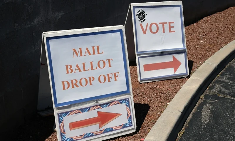 NORTH LAS VEGAS, NEVADA - JUNE 09: Signs direct people to the entrance of the Clark County Election Department, which is serving as both a primary election ballot drop-off point and an in-person voting center amid the coronavirus pandemic on June 9, 2020 in North Las Vegas, Nevada. This is the first time ballots have been mailed to all registered active voters in Nevada's history as the state holds its first-ever election done almost entirely by mail due to the risk of spreading COVID-19. The Clark County registrar said unofficial results of the election will be reported tonight but, final results will not be available until after the last ballots are counted on June 16 or 17. (Photo by Ethan Miller/Getty Images)