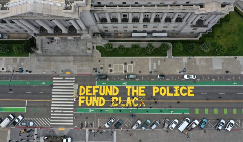 SAN FRANCISCO, CALIFORNIA - JULY 20: Protesters paint a mural that says 'defund the police' during a Strike For Black Lives demonstration outside of San Francisco City Hall on July 20, 2020 in San Francisco, California. The demonstration was part of the nationwide Strike for Black Lives effort which is calling for higher wages, better jobs, and Unions to help workers build economic power. (Photo by Justin Sullivan/Getty Images)