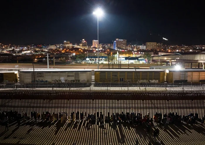 CIUDAD JUAREZ, MEXICO - DECEMBER 21: Migrants spend the night in a long line outside the U.S.-Mexico border fence while waiting to make asylum claims in El Paso, Texas on December 21, 2022 as seen from Ciudad Juarez, Mexico. Texas Governor Greg Abbott ordered 400 troops to the U.S.-Mexico border at El Paso, which is under a state of emergency due to a surge of migrants crossing from Mexico into the city. Border officials expect an even larger migrant surge at the border if the pandemic era Title 42 regulation is lifted. (Photo by John Moore/Getty Images)