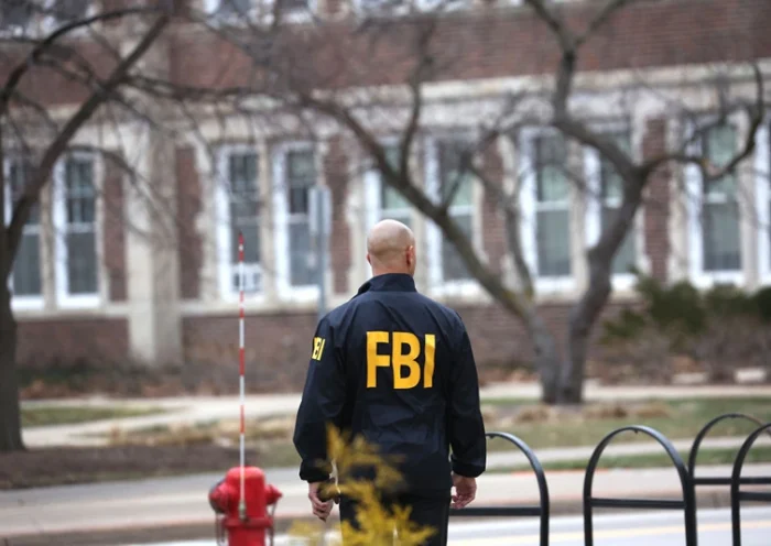EAST LANSING, MICHIGAN - FEBRUARY 16: An FBI agent stands outside of Berkey Hall on the campus of Michigan State University on February 16, 2023 in East Lansing, Michigan. FBI agents were there to assist students and university staff in retrieving items which were left behind on February 13, when the building was evacuated after a gunman opened fire there and at another building on campus. Three students were killed and five others critically wounded. The gunman shot and killed himself a short time later during a confrontation with law enforcement officials. (Photo by Scott Olson/Getty Images)