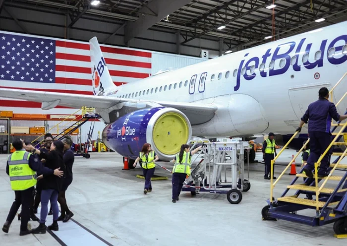 Employees of Jet Blue airlines work around an Airbus A320 passenger aircraft in a maintenance hangar of the company at JFK International Airport in New York on March 4, 2024, prior of a Career Discovery Week event. JetBlue and Spirit Airlines formally pulled the plug Monday on their merger, about six weeks after a federal judge ruled it violated US antitrust law. (Photo by Charly TRIBALLEAU / AFP) (Photo by CHARLY TRIBALLEAU/AFP via Getty Images)