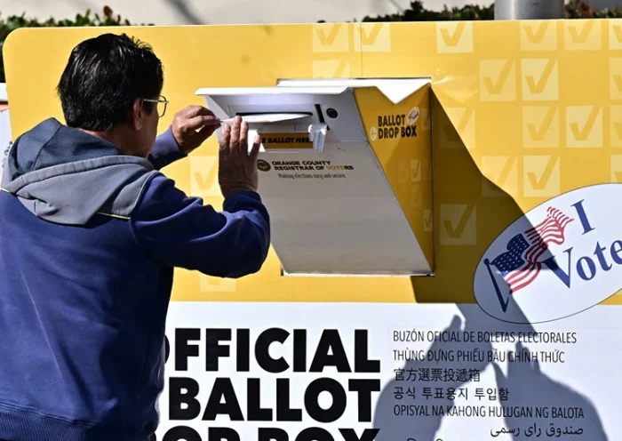 A man drops his ballot into a ballot box at the Orange County Registrar in Santa Ana, California on "Super Tuesday," March 5, 2024. Americans from 15 states and one territory vote simultaneously on "Super Tuesday," a campaign calendar milestone expected to leave Donald Trump a hair's breadth from securing the Republican Party's presidential nomination. (Photo by Frederic J. BROWN / AFP) (Photo by FREDERIC J. BROWN/AFP via Getty Images)