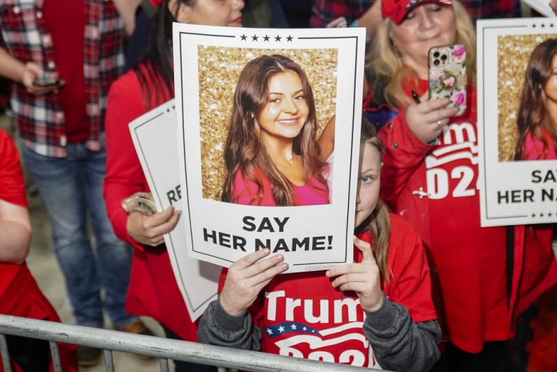 Supporters of former US President and 2024 presidential hopeful Donald Trump hold images of Laken Riley before he speaks at a 
