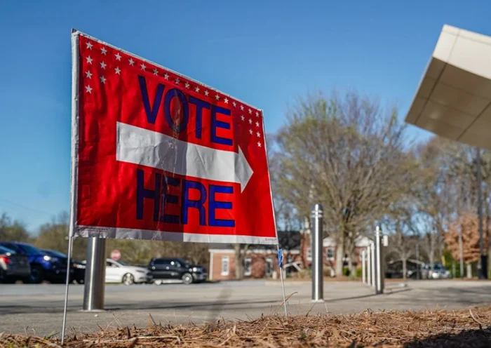 A "Vote Here" signs directs voters to a precinct during the presidential primary elections in Atlanta, Georgia, on March 12, 2024. (Photo by Elijah Nouvelage / AFP) (Photo by ELIJAH NOUVELAGE/AFP via Getty Images)