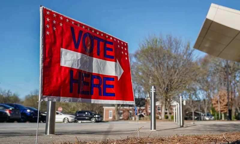 A "Vote Here" signs directs voters to a precinct during the presidential primary elections in Atlanta, Georgia, on March 12, 2024. (Photo by Elijah Nouvelage / AFP) (Photo by ELIJAH NOUVELAGE/AFP via Getty Images)