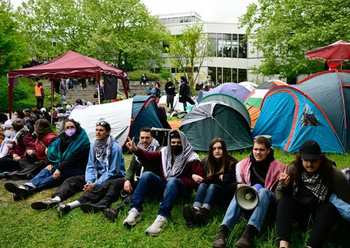 Pro-Palestinian activists sit in front of tents set up at the university campus of the Free University of Berlin, Germany, on May 7, 2024 as they demonstrate against Israel's war in the Gaza Strip which was sparked by Hamas's unprecedented October 7 attack. According to local media reports, activists set up a protest camp with tents in a courtyard of the university. The university has ordered the evacuation and called the police, who have cordoned off the area. (Photo by Tobias SCHWARZ / AFP) (Photo by TOBIAS SCHWARZ/AFP via Getty Images)