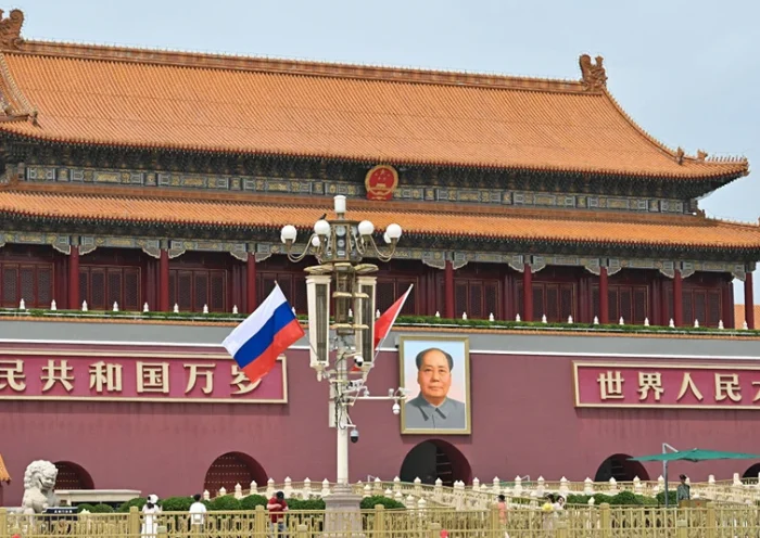 TOPSHOT - Russia's national flag flies beside the Chinese flag in front of Tiananmen Gate next to Tiananmen Square, during the state visit of Russia's president Vladimir Putin in Beijing on May 16, 2024. Leaders Xi Jinping and Vladimir Putin framed their nations' ties as a stabilising force in a chaotic world as they met May 16 in Beijing, where the Russian president is seeking greater Chinese support for his war effort in Ukraine and isolated economy. (Photo by HECTOR RETAMAL / AFP) (Photo by HECTOR RETAMAL/AFP via Getty Images)