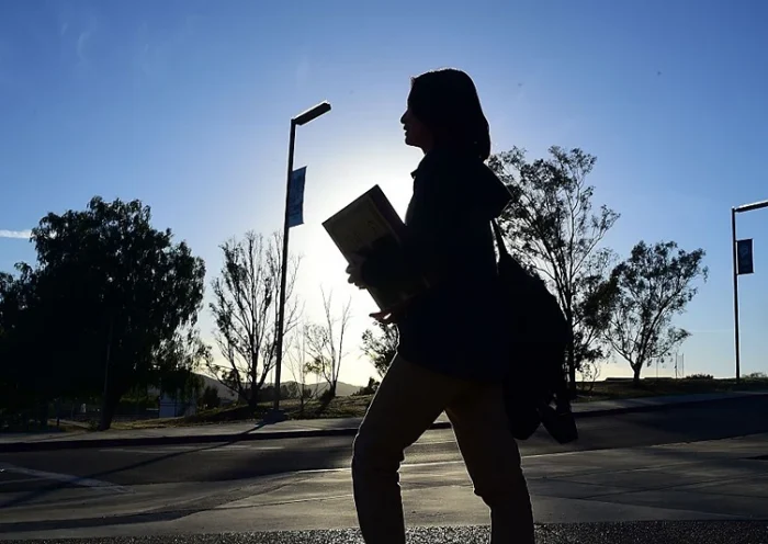 Chinese student Helen Zhou, from Chengdu, heads to Choir practice on campus at Linfield Christian School in Temecula, California on March 23, 2016. Growing up in mainland China, Hailun "Helen" Zhou always knew that she would finish her high school education in America, whatever the cost. But for thousands of Chinese teens flocking to US schools, the pursuit of the American dream can sometimes turn into a nightmare. / AFP / FREDERIC J. BROWN (Photo credit should read FREDERIC J. BROWN/AFP via Getty Images)