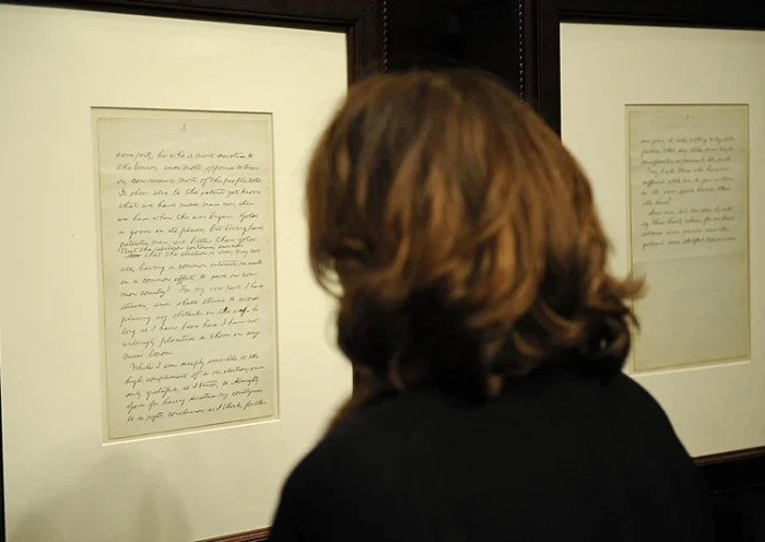 A woman reads part of a rare manuscript by Abraham Lincoln's 1864 reelection victory speech (Lot 51), calling on the country to unite amid civil war in 1864, which is on display during an auction at Christie's in New York, February 12, 2009. The manuscript sold for 3.4 million dollars, after commission, a world record for an US historical document during the sale which took place on the 200th anniversary of Lincoln's birth. AFP PHOTO/Emmanuel Dunand (Photo credit should read EMMANUEL DUNAND/AFP via Getty Images)