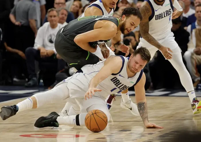 Dallas Mavericks guard Luka Doncic (77) and Minnesota Timberwolves forward Kyle Anderson (1) fight for a loose ball during the second quarter in game five of the western conference finals for the 2024 NBA playoffs at Target Center. Mandatory Credit: Bruce Kluckhohn-USA TODAY Sports