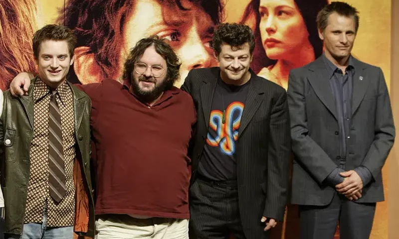 Director Peter Jackson (2nd/L) and cast members of 'The Lord of the Rings: The Return of the King' from left to right: Elijah Wood, Andy Serkis and Viggo Mortensen pose for photographers in Tokyo January 21, 2004. REUTERS/Yuriko Nakao/File Photo