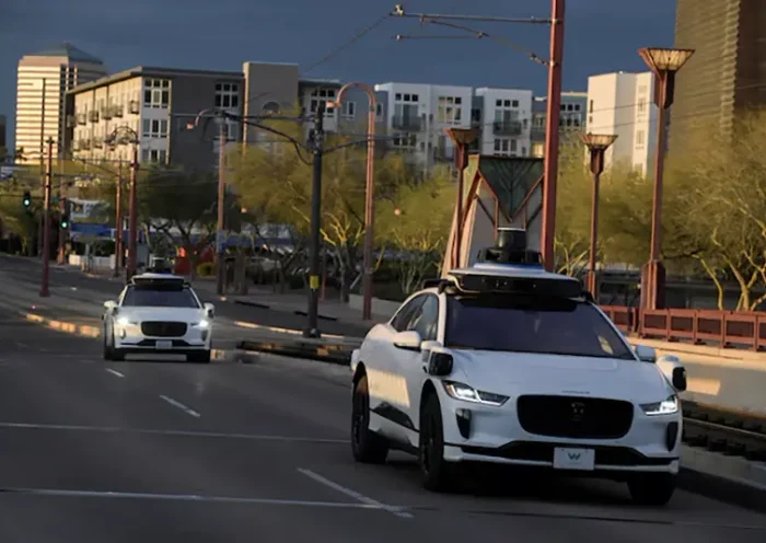 Two Waymo autonomous vehicles drive themselves down Central Avenue in Phoenix, Arizona, U.S., March 18, 2024. REUTERS/Caitlin O'Hara/File Photo