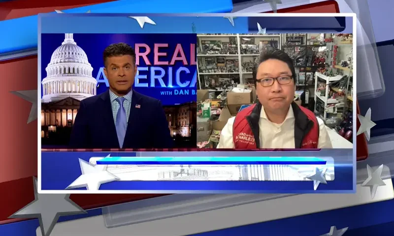 Video still from Real America on One America News Network showing a split screen of the host on the left side, and on the right side is the guest, Jonathan Choe.