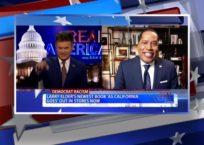 Video still from Real America on One America News Network showing a split screen of the host on the left side, and on the right side is the guest, Larry Elder.