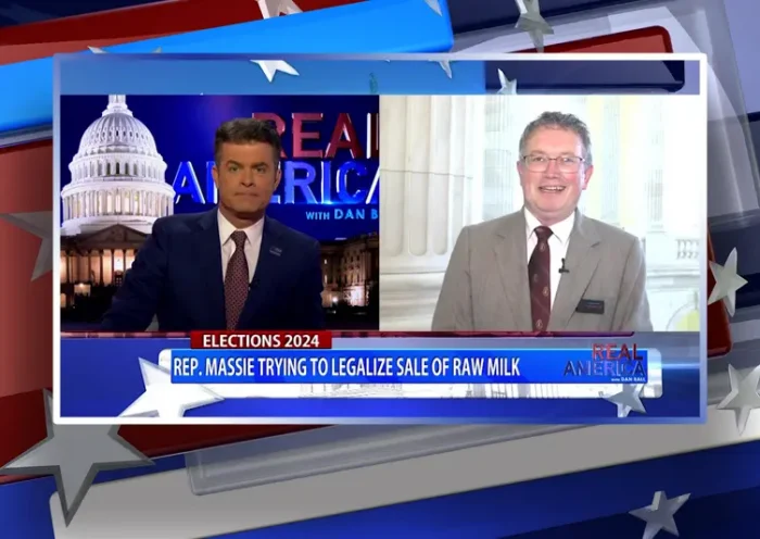Video still from Real America on One America News Network showing a split screen of the host on the left side, and on the right side is the guest, Rep. Thomas Massie.