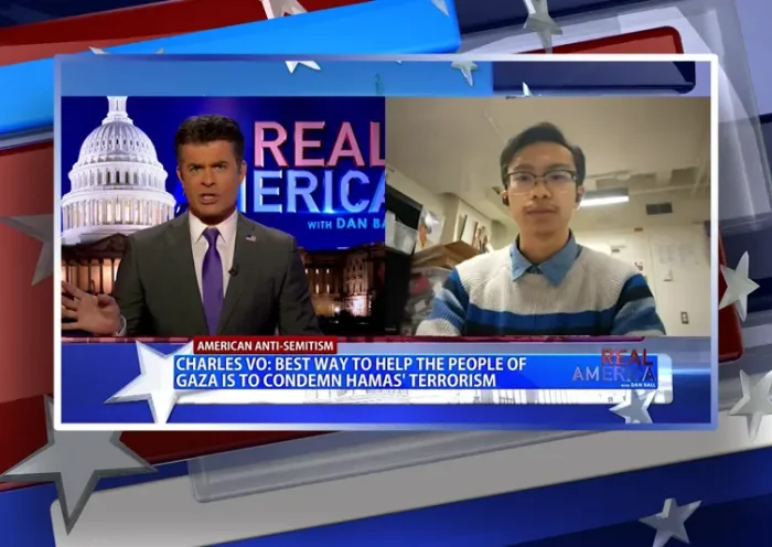 Video still from Real America on One America News Network showing a split screen of the host on the left side, and on the right side is the guest, Charles Vo.
