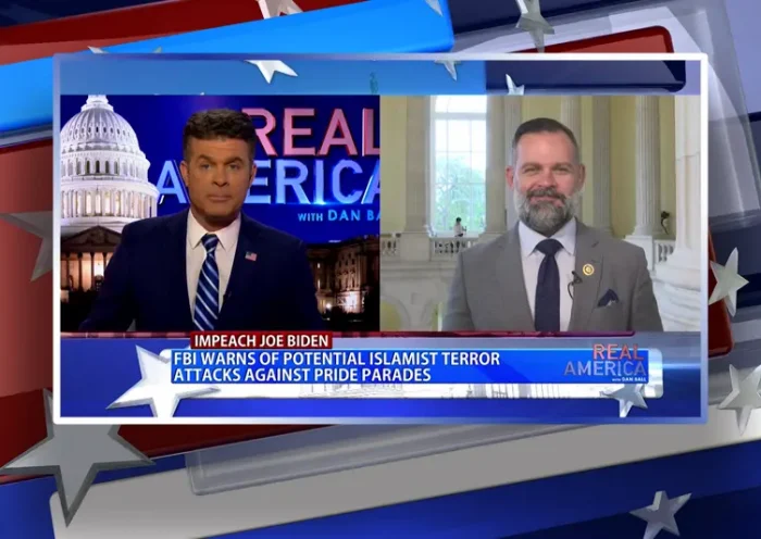 Video still from Real America on One America News Network showing a split screen of the host on the left side, and on the right side is the guest, Rep. Cory Mills.