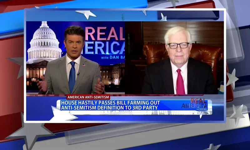 Video still from Real America on One America News Network showing a split screen of the host on the left side, and on the right side is the guest, Dennis Prager.