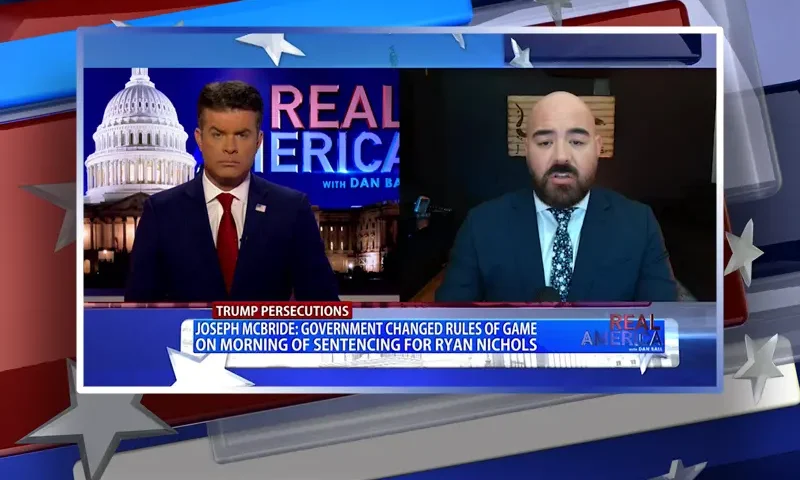 Video still from Real America on One America News Network showing a split screen of the host on the left side, and on the right side is the guest, Joseph McBride.