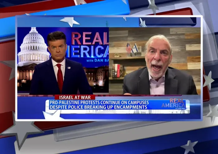 Video still from Real America on One America News Network showing a split screen of the host on the left side, and on the right side is the guest, Dov Hikind.